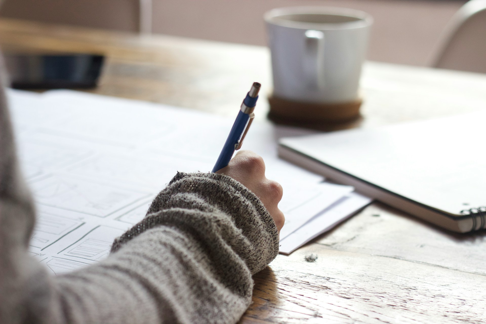 Person at a desk writing and planning.