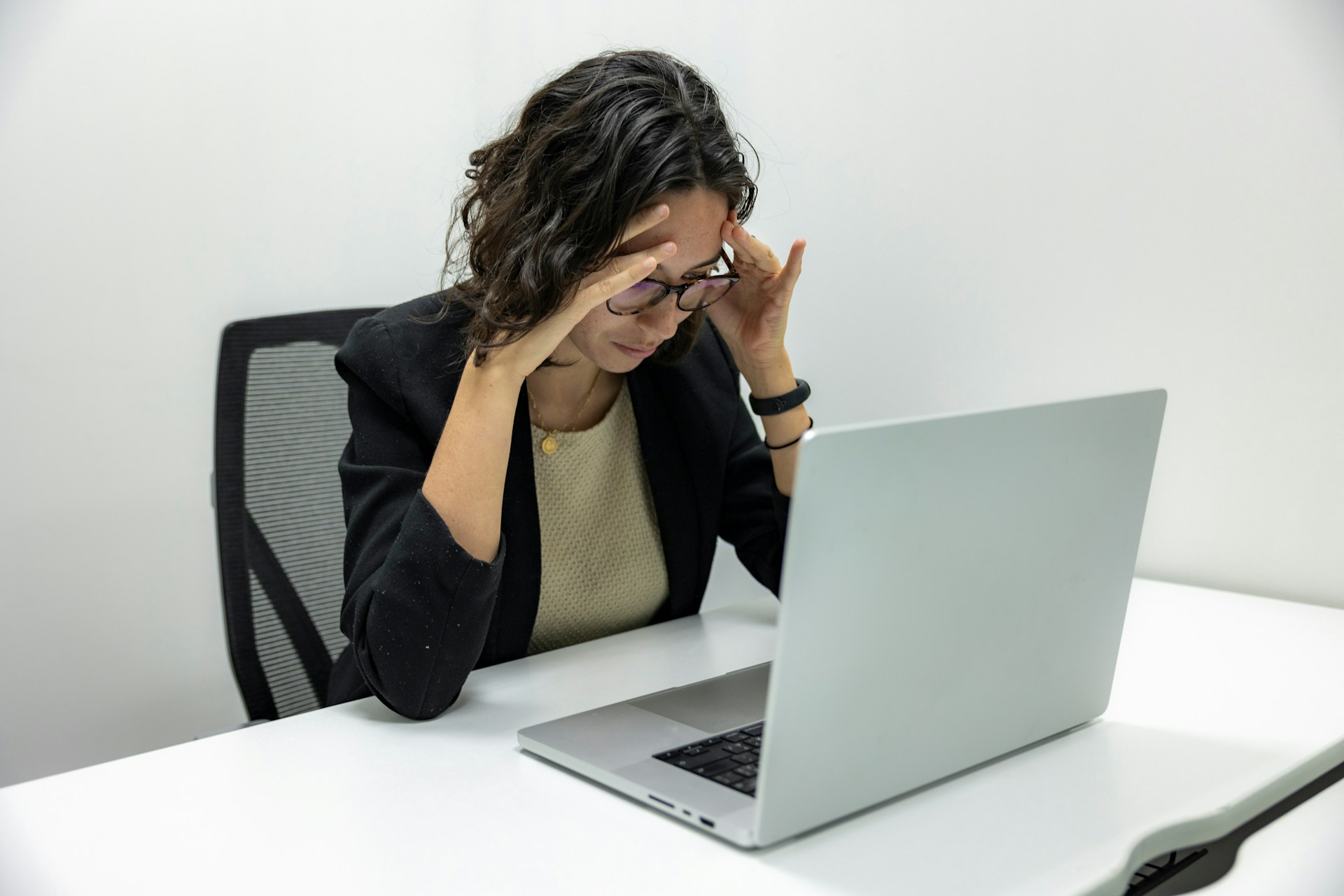 Stressed business owner at their desk in front of laptop.