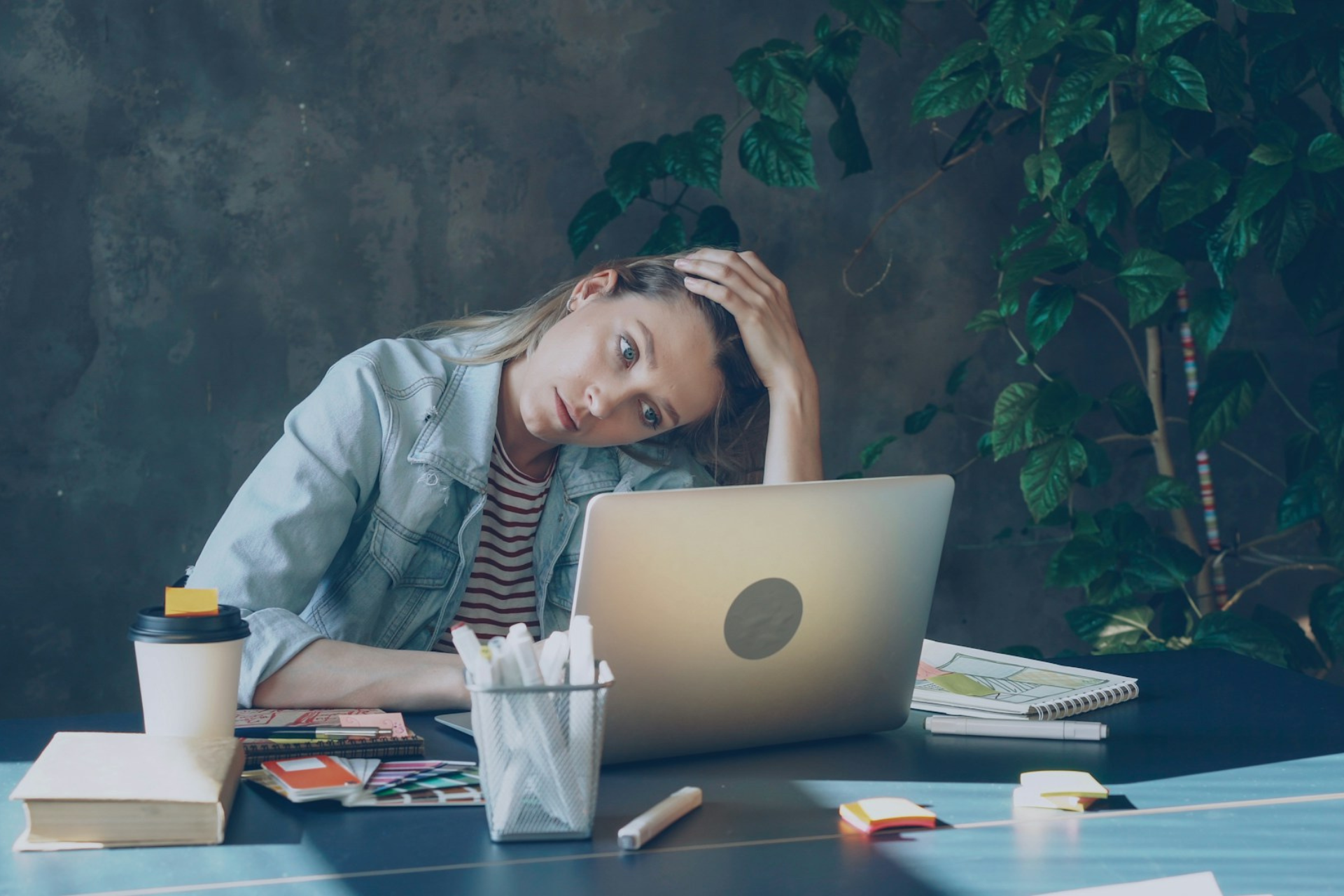 This photograph shows a woman at a desk that is tired after a long day working. It’s a stock image so the individuals should not be identified. It’s being used to illustrate that the article it represents is about Do You Own a Business or Just a Job with Overhead?. The text alternative is "Do You Own a Business or Just a Job with Overhead?" as this best describes the intended impression.